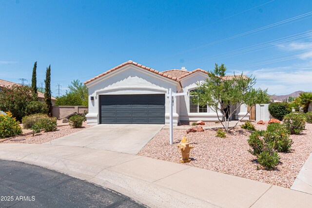 9791 N 118th Way, Scottsdale, AZ 85259 - view of front of house featuring a tiled roof, an attached garage, stucco siding, and driveway