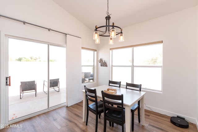 9791 N 118th Way, Scottsdale, AZ 85259 - dining area featuring a chandelier, wood finished floors, healthy amount of natural light, and vaulted ceiling