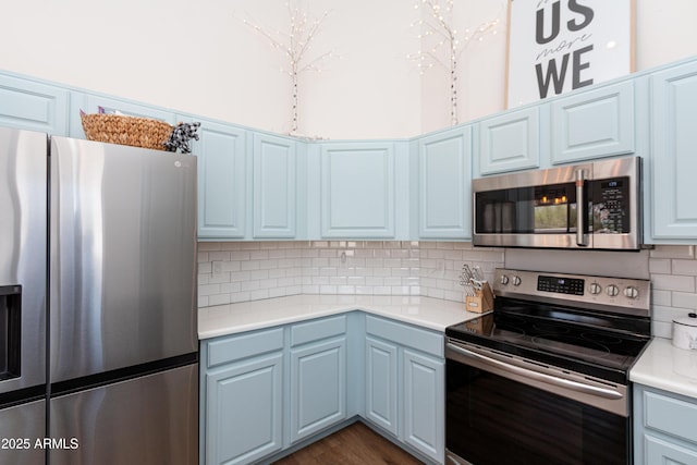 9791 N 118th Way, Scottsdale, AZ 85259 - kitchen featuring stainless steel appliances, light countertops, decorative backsplash, and blue cabinets