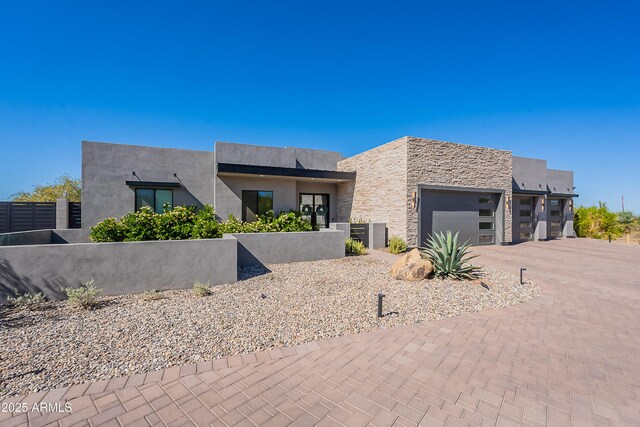 33766 N 86th St, Scottsdale, AZ 85266 - contemporary home with a garage, decorative driveway, stone siding, and stucco siding
