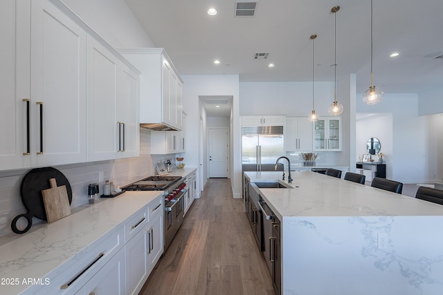 33766 N 86th St, Scottsdale, AZ 85266 - kitchen with premium appliances, tasteful backsplash, a large island, light wood-style flooring, and recessed lighting