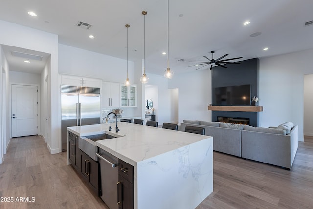 33766 N 86th St, Scottsdale, AZ 85266 - kitchen with a sink, stainless steel appliances, light stone countertops, decorative light fixtures, and light wood finished floors