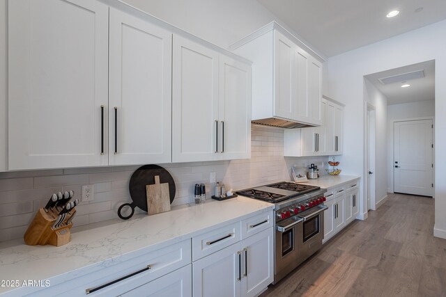33766 N 86th St, Scottsdale, AZ 85266 - kitchen with double oven range, white cabinetry, light wood-style floors, decorative backsplash, and light stone countertops