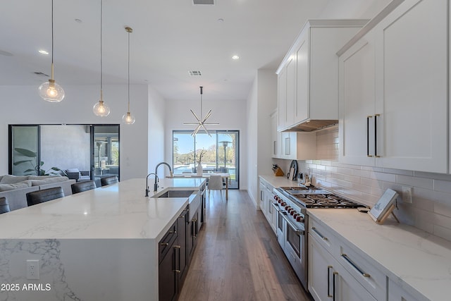 33766 N 86th St, Scottsdale, AZ 85266 - kitchen with double oven range, a sink, wood finished floors, tasteful backsplash, and white cabinetry
