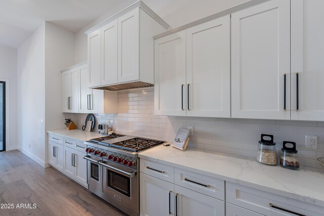33766 N 86th St, Scottsdale, AZ 85266 - kitchen with double oven range, white cabinetry, light wood-style flooring, and light stone countertops