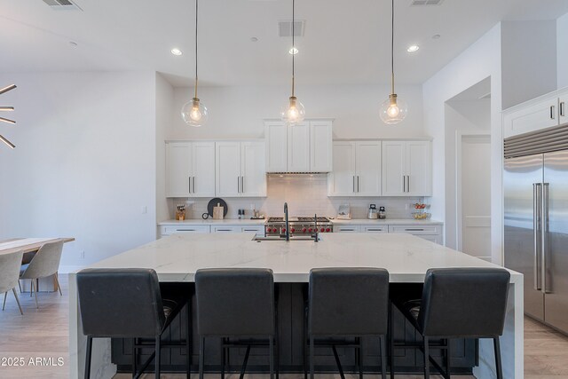 33766 N 86th St, Scottsdale, AZ 85266 - kitchen with stainless steel built in fridge, a sink, decorative backsplash, light wood-style floors, and white cabinetry