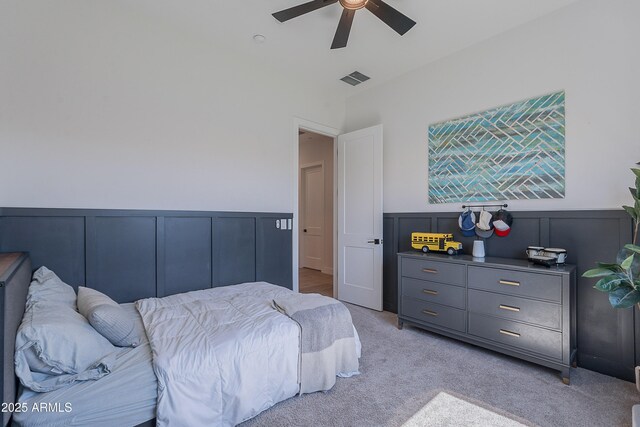 33766 N 86th St, Scottsdale, AZ 85266 - bedroom with a decorative wall, light colored carpet, a wainscoted wall, and ceiling fan