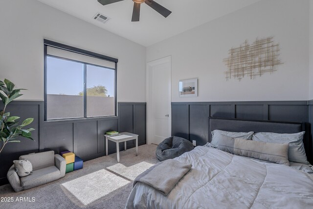 33766 N 86th St, Scottsdale, AZ 85266 - carpeted bedroom with wainscoting, a ceiling fan, and a decorative wall