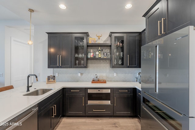 33766 N 86th St, Scottsdale, AZ 85266 - indoor wet bar with stainless steel appliances, tasteful backsplash, light wood finished floors, pendant lighting, and recessed lighting