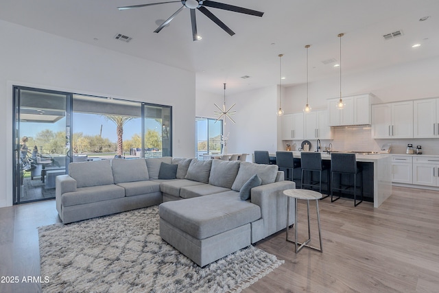 33766 N 86th St, Scottsdale, AZ 85266 - living area featuring ceiling fan, a high ceiling, light wood-type flooring, and recessed lighting