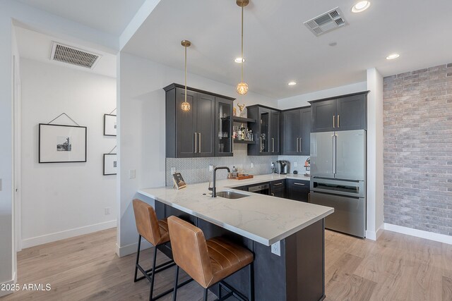 33766 N 86th St, Scottsdale, AZ 85266 - kitchen with a sink, light stone counters, baseboards, a peninsula, and freestanding refrigerator