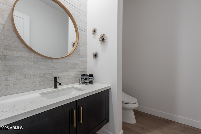 33766 N 86th St, Scottsdale, AZ 85266 - half bathroom featuring tasteful backsplash, toilet, baseboards, vanity, and wood finished floors