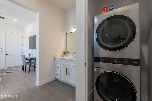 33766 N 86th St, Scottsdale, AZ 85266 - washroom featuring stacked washer and clothes dryer, baseboards, and dark tile patterned flooring