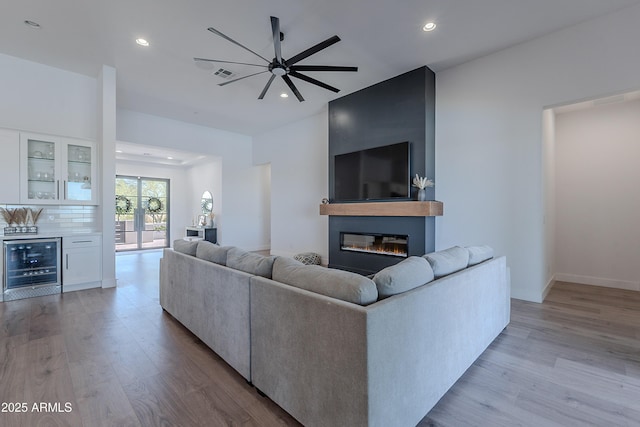 33766 N 86th St, Scottsdale, AZ 85266 - living room featuring wine cooler, a dry bar, wood finished floors, recessed lighting, and a fireplace