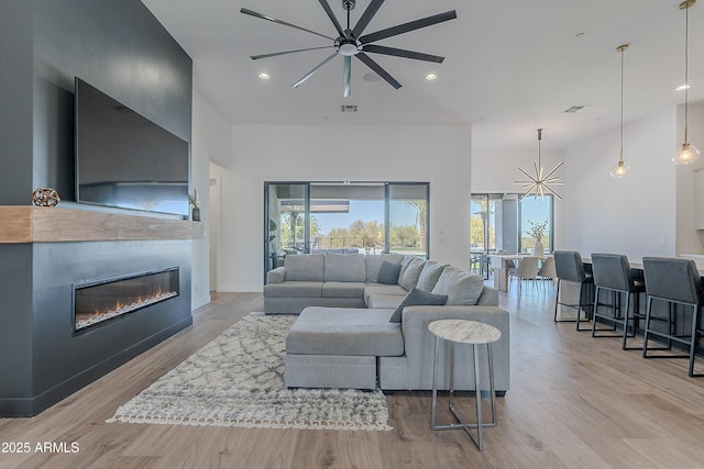 33766 N 86th St, Scottsdale, AZ 85266 - living room featuring ceiling fan, light wood-style floors, a glass covered fireplace, and recessed lighting