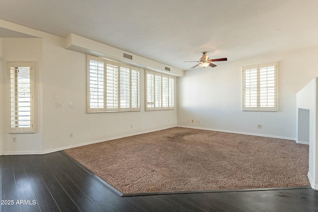 empty room featuring ceiling fan and dark hardwood / wood-style floors