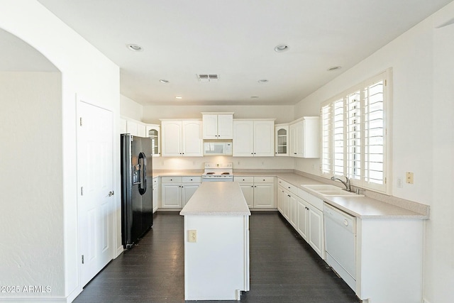 kitchen featuring white cabinetry, sink, white appliances, and a center island