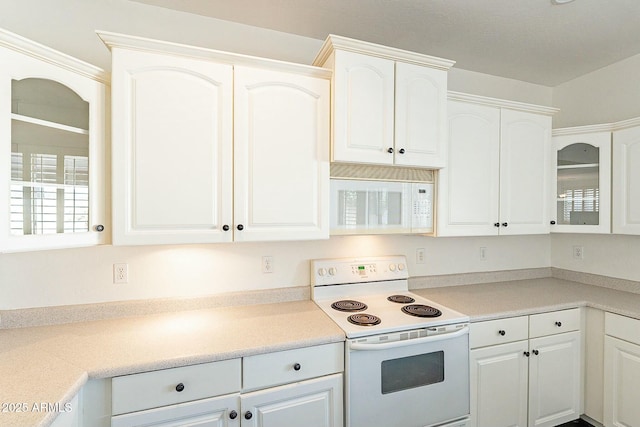 kitchen with white cabinetry and white appliances