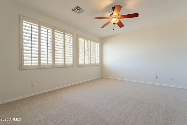 unfurnished room with ceiling fan and light carpet