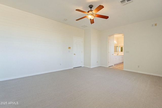 empty room featuring ceiling fan and light carpet