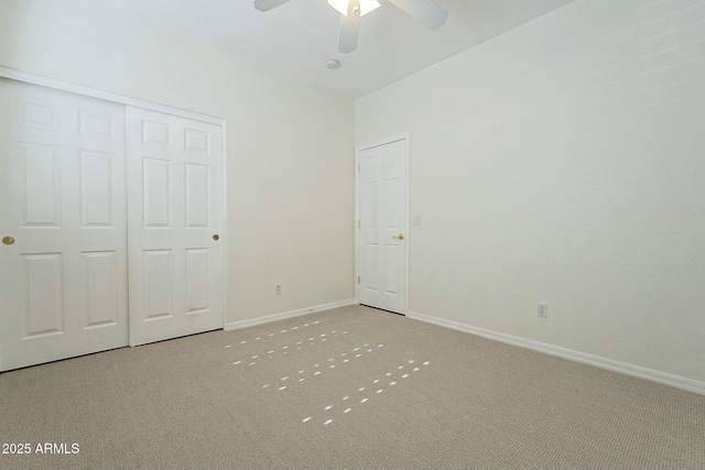 unfurnished bedroom with ceiling fan, a closet, and carpet flooring