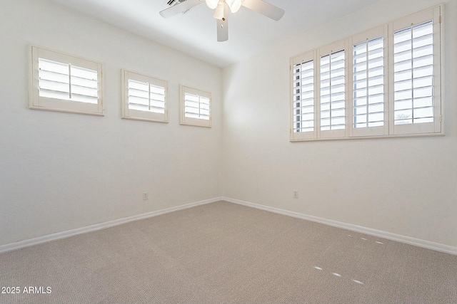 carpeted empty room featuring ceiling fan