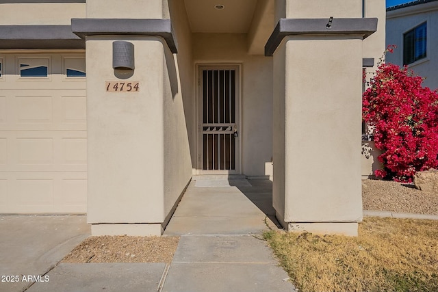 view of exterior entry with a garage