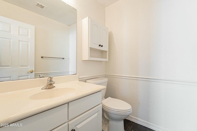 bathroom with toilet and vanity