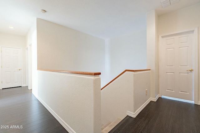 corridor with dark hardwood / wood-style floors