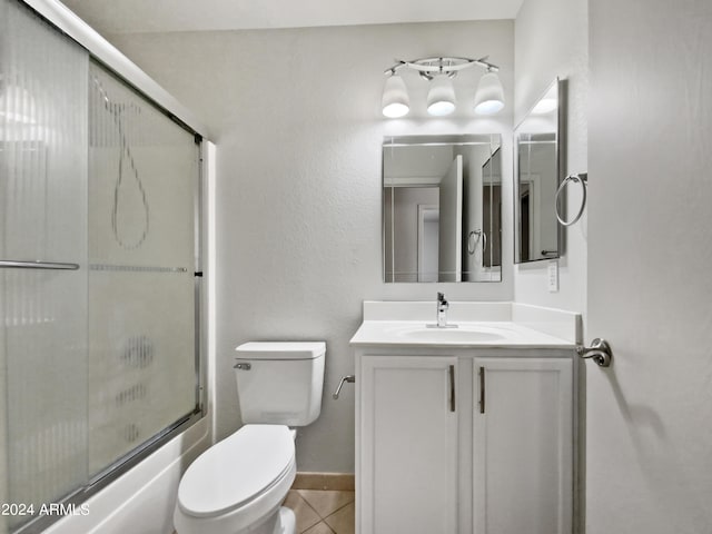 full bathroom with tile patterned floors, vanity, toilet, and shower / bath combination with glass door