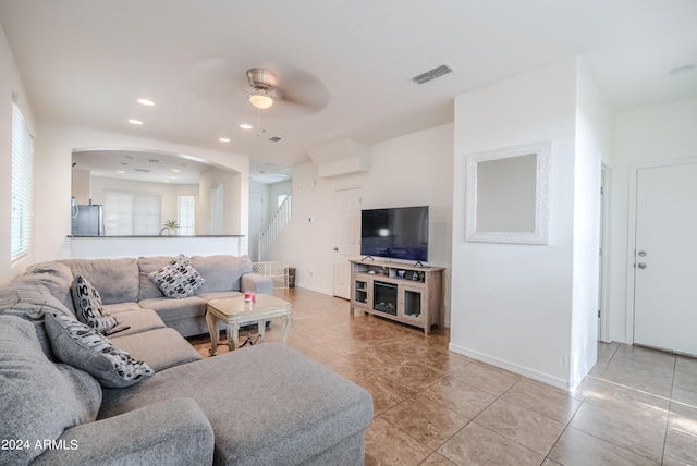 living room with light tile patterned floors and ceiling fan