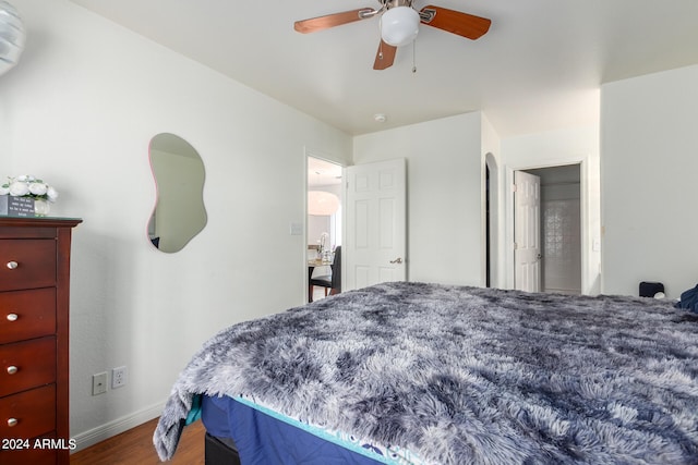 bedroom with ceiling fan and hardwood / wood-style flooring