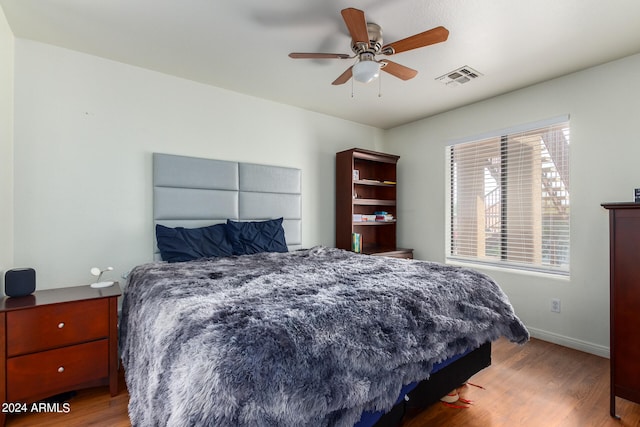 bedroom with hardwood / wood-style floors and ceiling fan