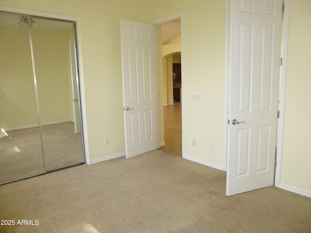 6687 S Banning St, Gilbert, AZ 85298 - unfurnished bedroom featuring arched walkways, carpet floors, baseboards, and a closet