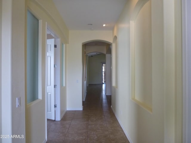 6687 S Banning St, Gilbert, AZ 85298 - corridor with arched walkways, dark tile patterned floors, baseboards, and recessed lighting