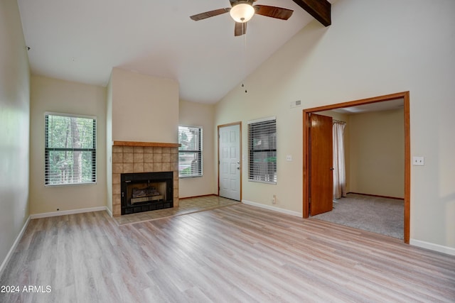 unfurnished living room with light hardwood / wood-style floors, high vaulted ceiling, a wealth of natural light, and ceiling fan