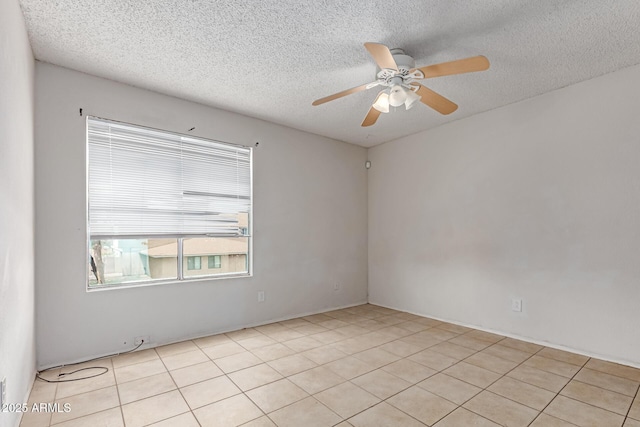 unfurnished room with a textured ceiling, a ceiling fan, and light tile patterned floors