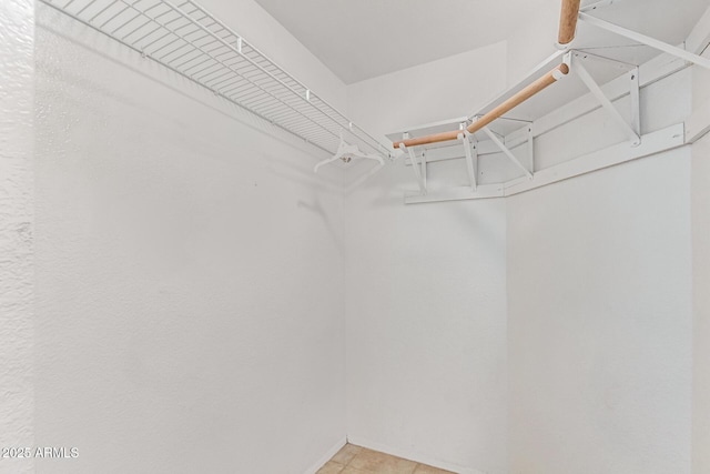 spacious closet with light tile patterned flooring
