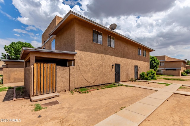 back of house with stucco siding