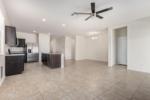 kitchen featuring stainless steel fridge, visible vents, open floor plan, and a center island