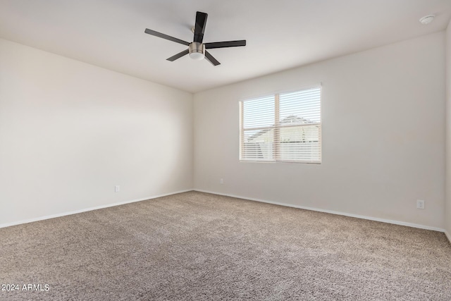 unfurnished room with carpet, ceiling fan, and baseboards