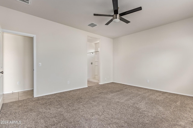 unfurnished bedroom with baseboards, visible vents, a ceiling fan, ensuite bathroom, and carpet flooring