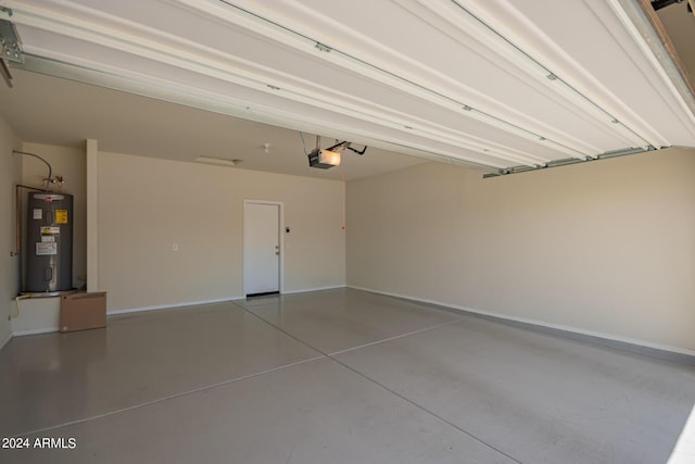 garage featuring a garage door opener, electric water heater, and baseboards