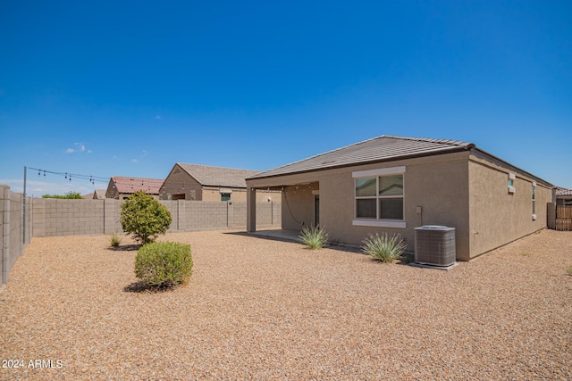 view of front of property featuring a patio area, a fenced backyard, and stucco siding