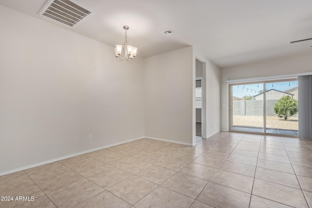 spare room with an inviting chandelier, baseboards, light tile patterned floors, and visible vents