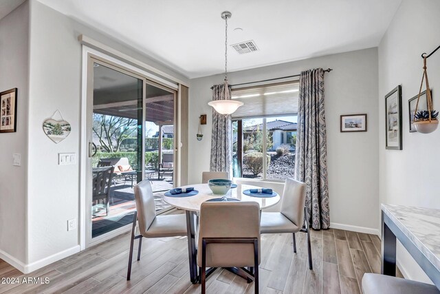 dining space with light hardwood / wood-style flooring