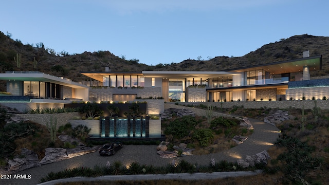 exterior space featuring a balcony and a mountain view