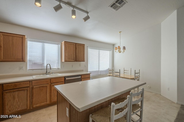 kitchen featuring a healthy amount of sunlight, dishwasher, visible vents, and a sink