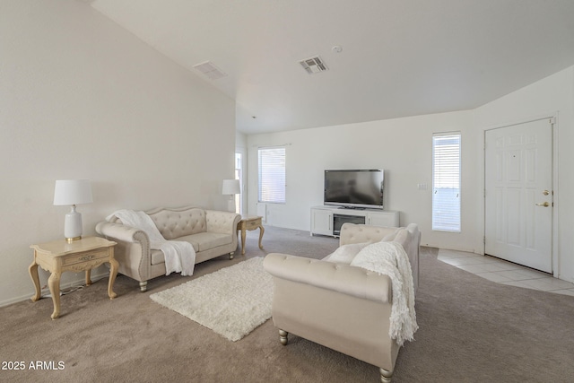 living room with visible vents, plenty of natural light, light carpet, and light tile patterned flooring