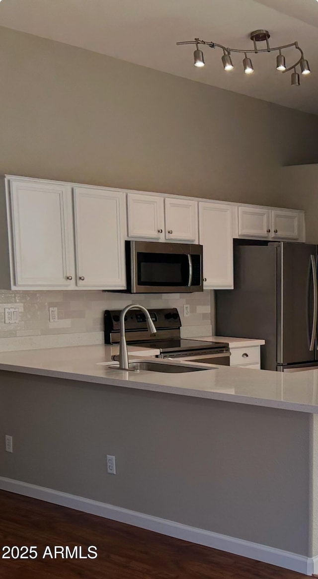 kitchen featuring white cabinetry, dark hardwood / wood-style floors, and stainless steel appliances